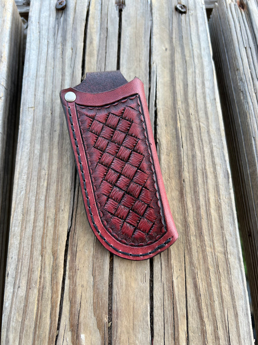 Handmade mahogany red leather knife sheath with hand-stamped basketweave design, vertical right-side carry, by Cherokee Rose Custom Leather.