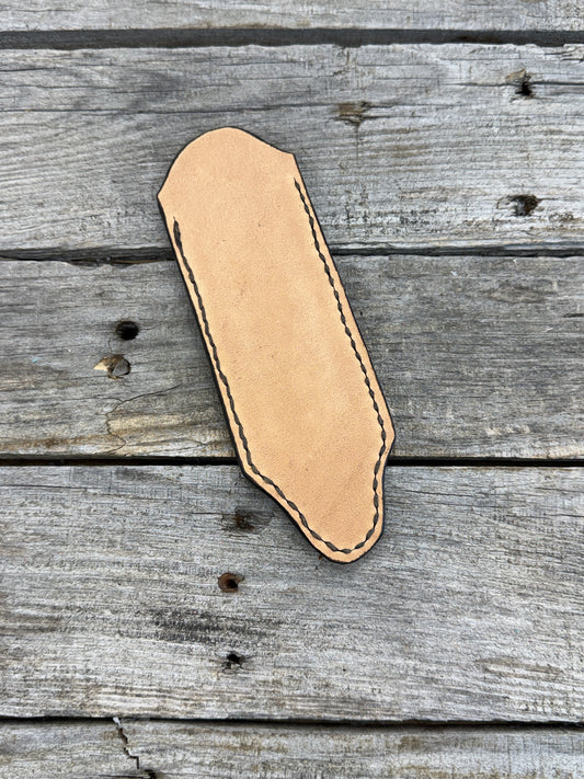 Hand tooled leather cast iron skillet handle cover with oak leaf and acorn carving, light tan dye, handmade by Cherokee Rose Custom Leather in East Texas.