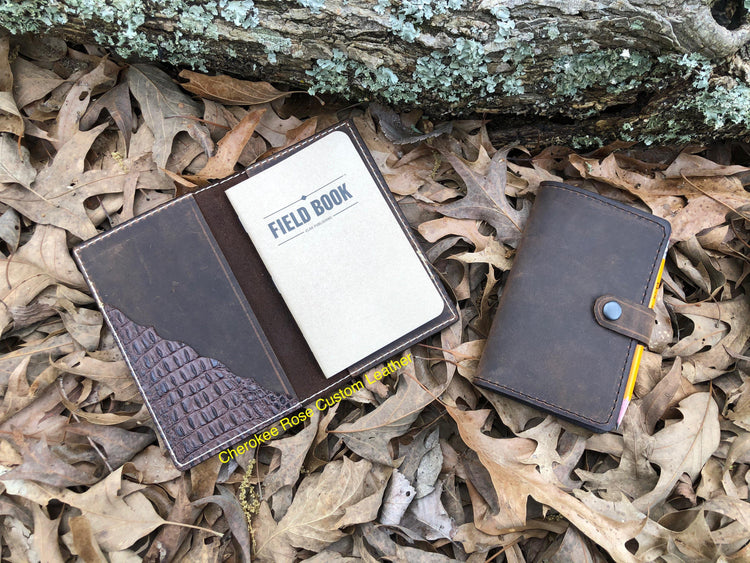 Hand tooled leather cover accessories including eyeglass cases and notebook covers, handmade by Cherokee Rose Custom Leather in East Texas