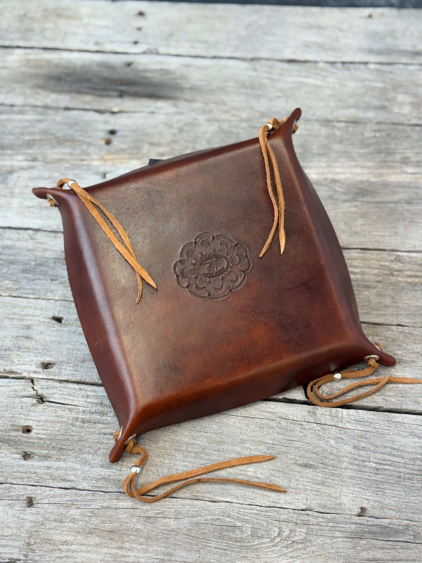 Back of handmade leather valet tray showing smooth finished leather and Cherokee Rose maker's mark