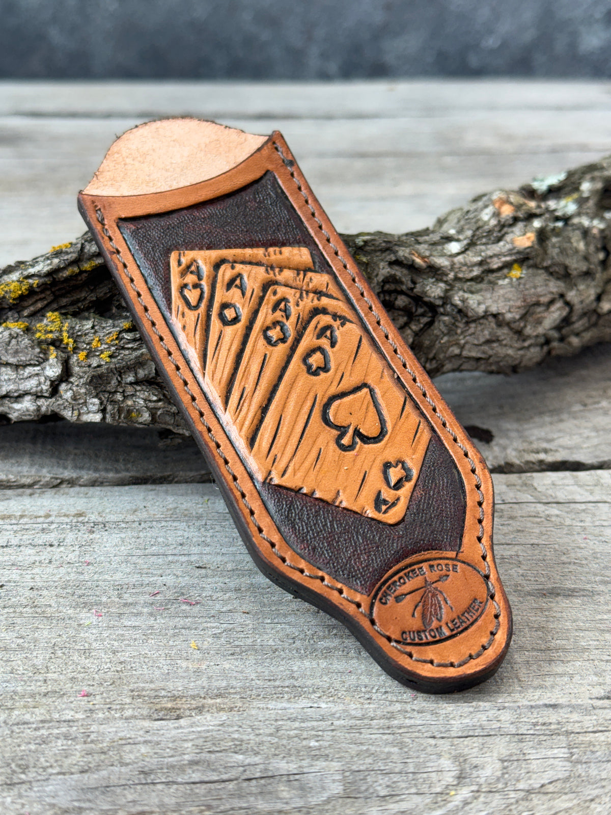 custom leather tooled cast iron skillet handle with playing card design on a wooden surface