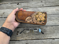 Hand tooled leather eyeglasses case with sunflower floral design and hand stitching, handmade by Cherokee Rose Custom Leather