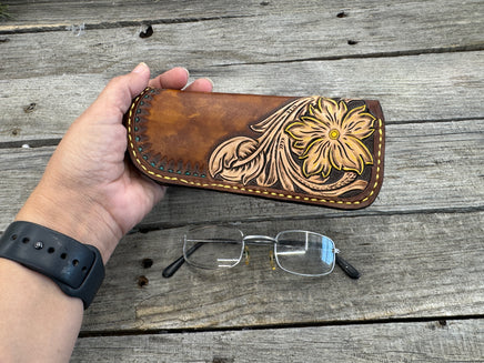 Hand tooled leather eyeglasses case with sunflower floral design and hand stitching, handmade by Cherokee Rose Custom Leather