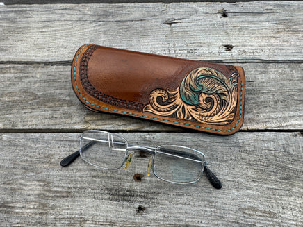Hand tooled leather eyeglasses case with turquoise feather and floral corner design, handmade by Cherokee Rose Custom Leather