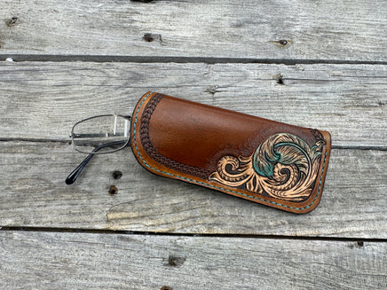 Hand tooled leather eyeglasses case with turquoise feather and floral corner design, handmade by Cherokee Rose Custom Leather