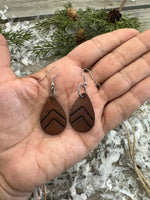 Small dark chocolate leather teardrop earrings with embossed Chevron lines and sterling silver hooks, handmade by Cherokee Rose Custom Leather in East Texas.