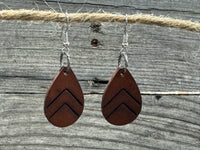 Small dark chocolate leather teardrop earrings with embossed Chevron lines and sterling silver hooks, handmade by Cherokee Rose Custom Leather in East Texas.