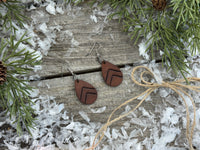 Small dark chocolate leather teardrop earrings with embossed Chevron lines and sterling silver hooks, handmade by Cherokee Rose Custom Leather in East Texas.