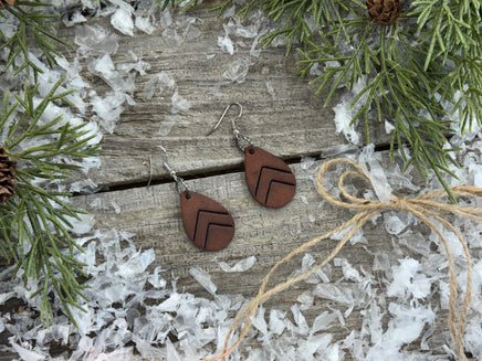 Small dark chocolate leather teardrop earrings with embossed Chevron lines and sterling silver hooks, handmade by Cherokee Rose Custom Leather in East Texas.