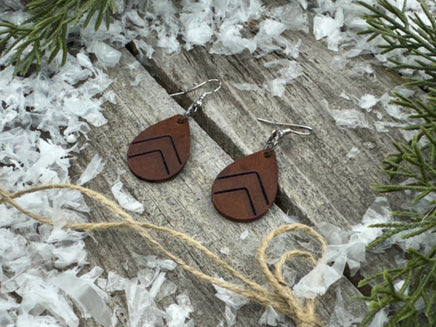 Small dark chocolate leather teardrop earrings with embossed Chevron lines and sterling silver hooks, handmade by Cherokee Rose Custom Leather in East Texas.