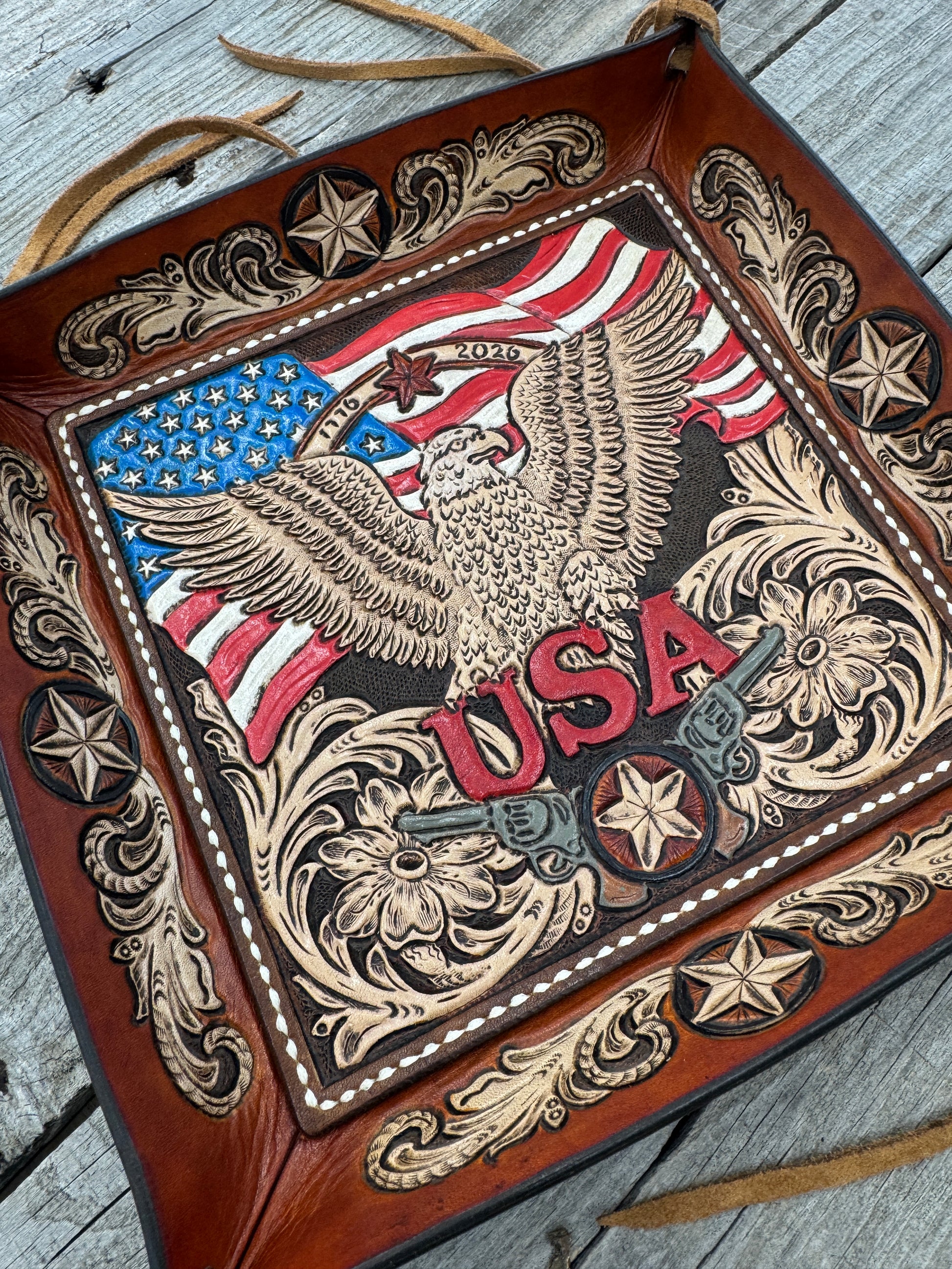 Close-up of hand tooled American eagle and flag artwork on patriotic leather valet tray