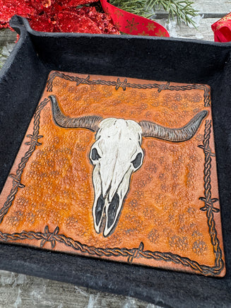 Hand-tooled leather valet tray with carved Texas longhorn skull and barbed wire border, black-dyed leather tray handmade by Cherokee Rose Custom Leather in Texas.