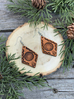 Diamond-shaped leather earrings with stamped flower design and sterling silver ear wires, handmade by Cherokee Rose Custom Leather in East Texas.