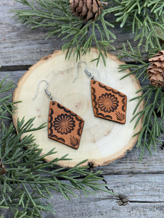 Diamond-shaped leather earrings with stamped flower design and sterling silver ear wires, handmade by Cherokee Rose Custom Leather in East Texas.