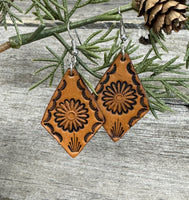 Diamond-shaped leather earrings with stamped flower design and sterling silver ear wires, handmade by Cherokee Rose Custom Leather in East Texas.