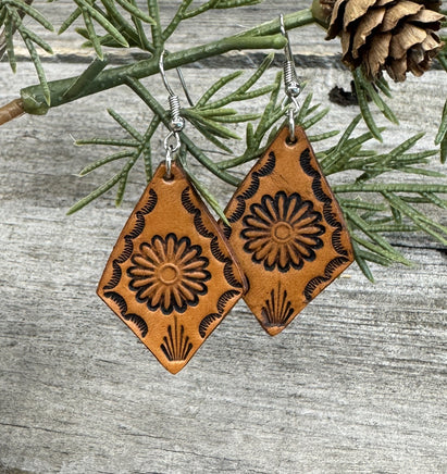 Diamond-shaped leather earrings with stamped flower design and sterling silver ear wires, handmade by Cherokee Rose Custom Leather in East Texas.