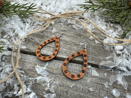 Teardrop-shaped leather earrings with hand-stamped dotted border and sterling silver ear wires, handmade by Cherokee Rose Custom Leather in East Texas.
