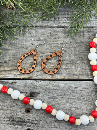 Teardrop-shaped leather earrings with hand-stamped dotted border and sterling silver ear wires, handmade by Cherokee Rose Custom Leather in East Texas.