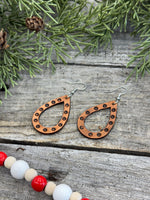 Teardrop-shaped leather earrings with hand-stamped dotted border and sterling silver ear wires, handmade by Cherokee Rose Custom Leather in East Texas.