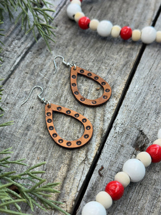 Teardrop-shaped leather earrings with hand-stamped dotted border and sterling silver ear wires, handmade by Cherokee Rose Custom Leather in East Texas.