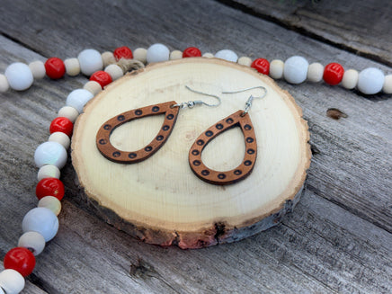 Teardrop-shaped leather earrings with hand-stamped dotted border and sterling silver ear wires, handmade by Cherokee Rose Custom Leather in East Texas.