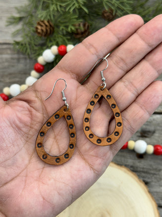 Teardrop-shaped leather earrings with hand-stamped dotted border and sterling silver ear wires, handmade by Cherokee Rose Custom Leather in East Texas.