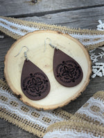 Large hand-stamped leather teardrop earrings with flower and geometric design, chocolate brown with sterling silver hooks, handmade by Cherokee Rose Custom Leather in East Texas.