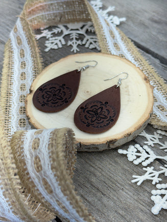 Large hand-stamped leather teardrop earrings with flower and geometric design, chocolate brown with sterling silver hooks, handmade by Cherokee Rose Custom Leather in East Texas.