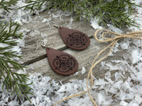 Large hand-stamped leather teardrop earrings with flower and geometric design, chocolate brown with sterling silver hooks, handmade by Cherokee Rose Custom Leather in East Texas.