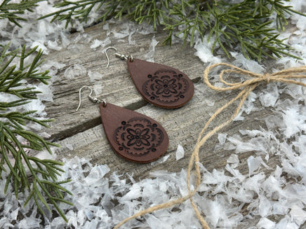 Large hand-stamped leather teardrop earrings with flower and geometric design, chocolate brown with sterling silver hooks, handmade by Cherokee Rose Custom Leather in East Texas.