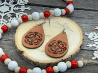 Large light tan teardrop leather earrings with hand-stamped geometric design and sterling silver hooks, handmade by Cherokee Rose Custom Leather in East Texas.