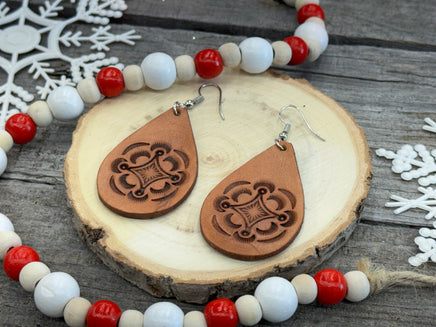 Large light tan teardrop leather earrings with hand-stamped geometric design and sterling silver hooks, handmade by Cherokee Rose Custom Leather in East Texas.