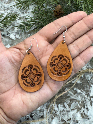 Large light tan teardrop leather earrings with hand-stamped geometric design and sterling silver hooks, handmade by Cherokee Rose Custom Leather in East Texas.