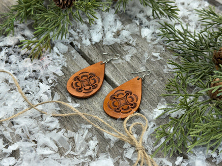 Large light tan teardrop leather earrings with hand-stamped geometric design and sterling silver hooks, handmade by Cherokee Rose Custom Leather in East Texas.