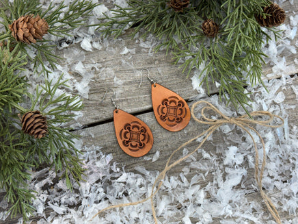 Large light tan teardrop leather earrings with hand-stamped geometric design and sterling silver hooks, handmade by Cherokee Rose Custom Leather in East Texas.