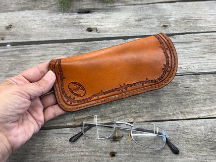 Hand stamped leather eyeglasses case with barbed wire and geometric Western pattern, handmade by Cherokee Rose Custom Leather