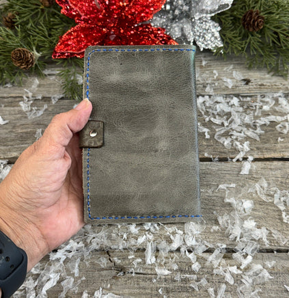 Handmade grey oil-tanned leather memo pad holder with black pigskin interior, royal blue stitching, and silver snap closure by Cherokee Rose Custom Leather.
