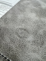 Close-up of a textured surface with a circular logo and text.