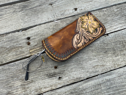 Hand tooled leather eyeglasses case with sunflower floral design and hand stitching, handmade by Cherokee Rose Custom Leather