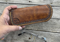 Hand tooled leather eyeglasses case with sunflower floral design and hand stitching, handmade by Cherokee Rose Custom Leather