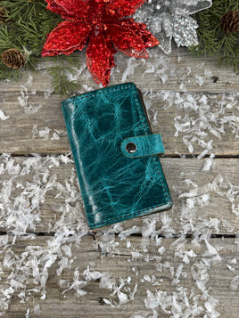 Handmade turquoise oil-tanned leather memo pad holder with black stitching and gunmetal snap closure, crafted by Cherokee Rose Custom Leather in East Texas.