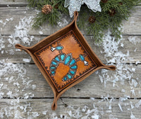 Hand-tooled leather valet tray with turquoise squash blossom necklace design and geometric stamped border, handmade by Cherokee Rose Custom Leather in Texas.