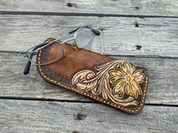 Hand tooled leather eyeglasses case with sunflower floral design and hand stitching, handmade by Cherokee Rose Custom Leather