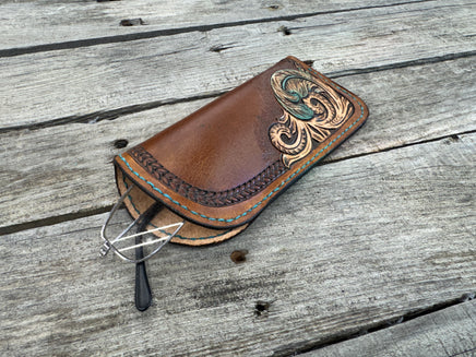 Hand tooled leather eyeglasses case with turquoise feather and floral corner design, handmade by Cherokee Rose Custom Leather