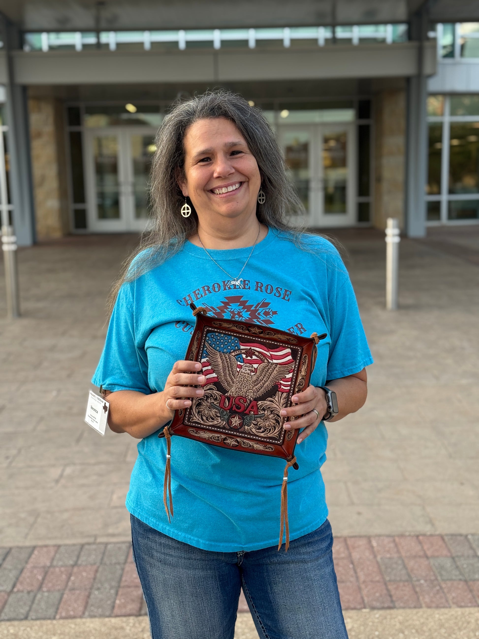 Leather artist holding one-of-a-kind patriotic eagle valet tray at the 2026 Heart of Texas Leather Show