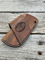 Handmade rustic brown leather knife sheath with black rivet hardware, horizontal carry design for small pocket knives by Cherokee Rose Custom Leather.