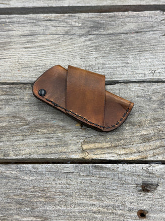 Handmade rustic brown leather knife sheath with black rivet hardware, horizontal carry design for small pocket knives by Cherokee Rose Custom Leather.