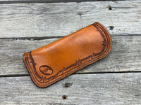 Hand stamped leather eyeglasses case with barbed wire and geometric Western pattern, handmade by Cherokee Rose Custom Leather