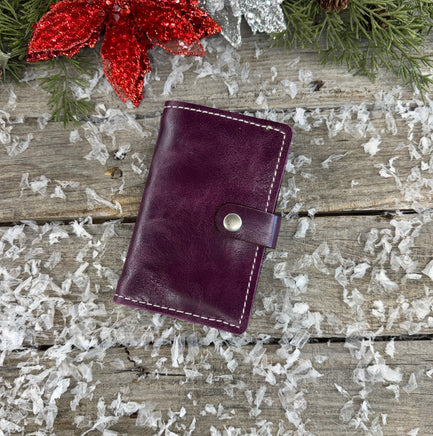 Handmade plum purple oil-tanned leather memo pad holder with cream stitching and antique nickel snap, crafted by Cherokee Rose Custom Leather in East Texas.
