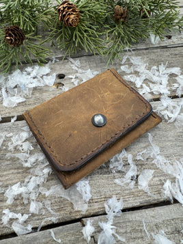 Handmade Crazy Horse oil-tanned leather card wallet in rustic brown with metal snap closure, crafted by Cherokee Rose Custom Leather in East Texas.